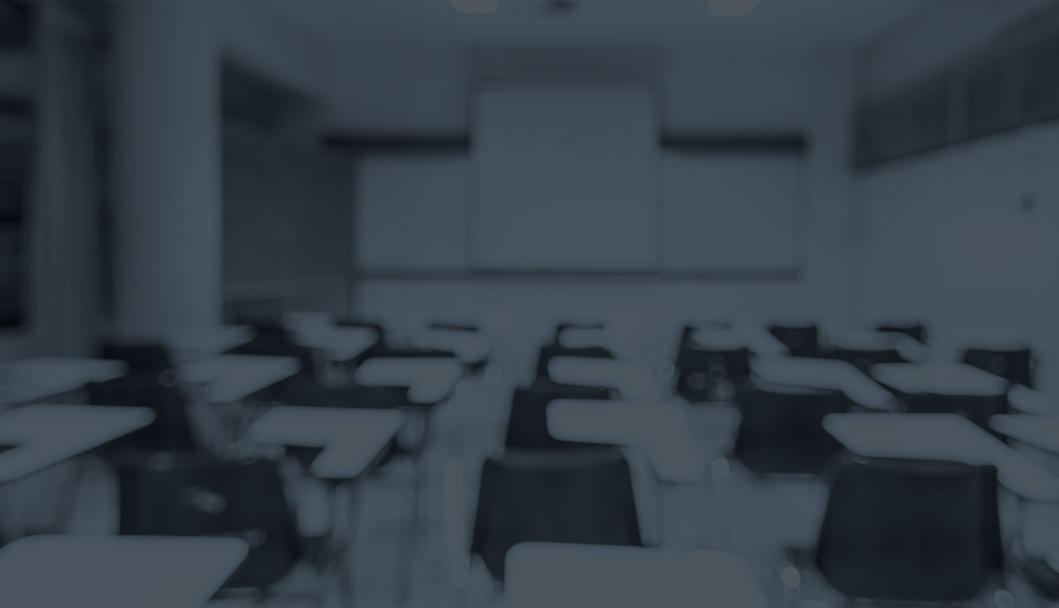 an unfocused picture of empty classroom desks